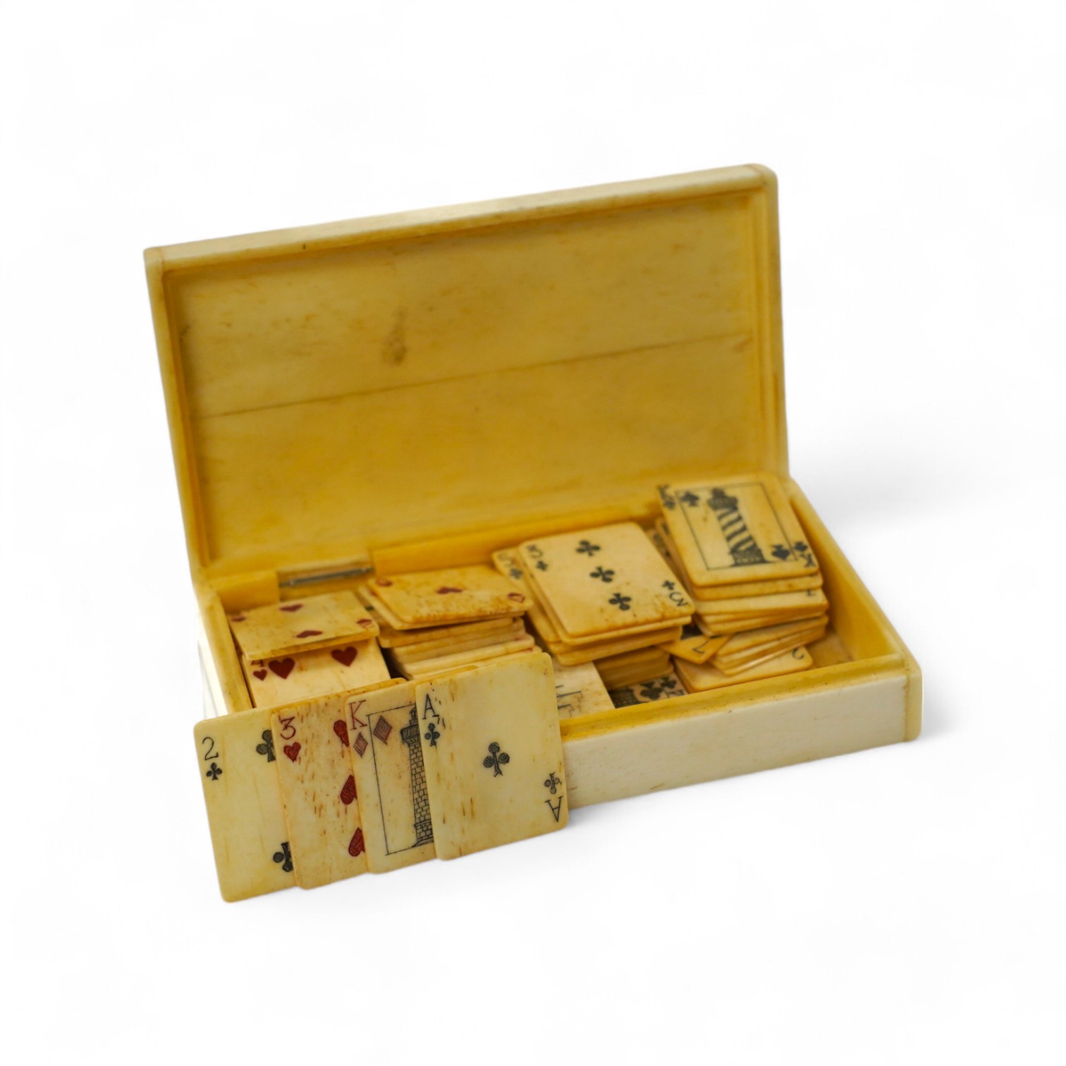 A set of bone scrimshaw type miniature playing cards, in box engraved with a ship and lighthouses, 11cm. Condition - good